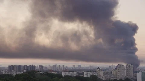 Huge column of thick black smoke rising high over Kyiv skyline  Video stock 338078276
