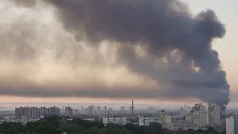 Huge column of thick black smoke rising high over Kyiv skyline  Video stock 338079651