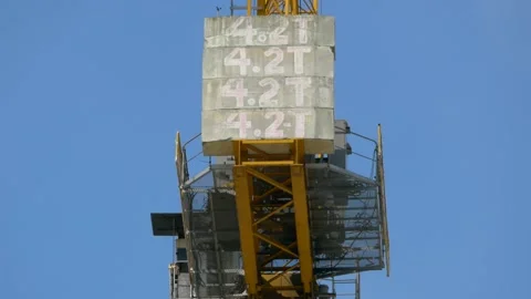 Huge construction crane rotating, showing its counterweights as it lifts. Stock Footage 150107324
