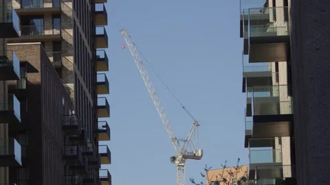Huge Construction Tower Crane Between Apartment Buildings Constructing New Real Stock Footage 333519408