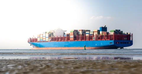 A huge container ship on the river Elbe near Cuxhaven, Germany. Stock Photos