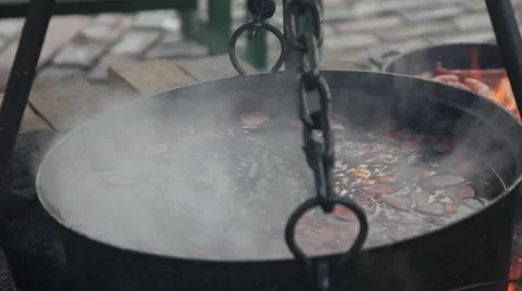 Huge copper cauldron with tasty mulled wine cooked over open fire Stock Footage 47674333