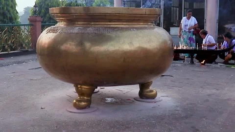 Huge copper incense holder with devotee offering pryers at morning from flat  Video stock 169065374