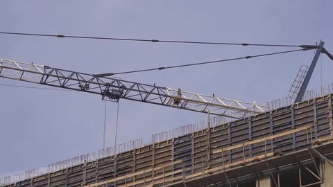 Huge crane rising between building under construction Stock-Footage 84665931