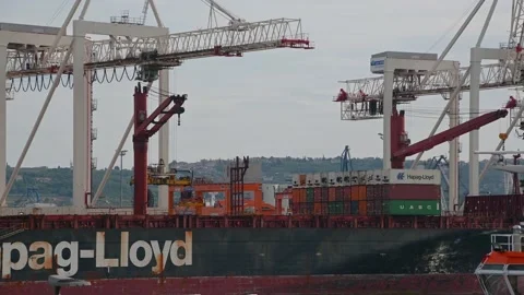 Huge cranes unloading and loading Hapag-Lloyd container ship in Port of Koper Video stock 158494093