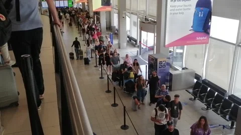 Huge crowd at the airport, endless queue due to flight delays, passengers Video stock 205254994