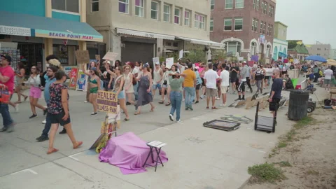 A Huge Crowd Of Chanting Protesters March Down Venice Beach Stock Footage 198784431
