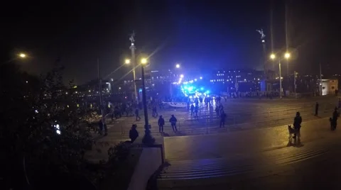 Huge crowd of fans walking through night Prague accompanied by police cars Video stock 58679166