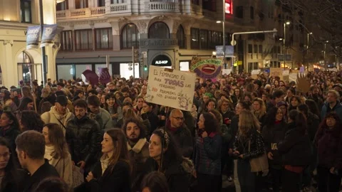 Huge crowd marching and holding placards in a big Avenue at International Women' Stock Footage 235462760