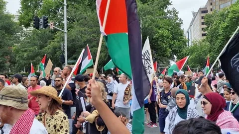 HUGE CROWD MARCHING THROUGH SYDNEY CITY DEMANDING GAZA CEASE-FIRE 2023 Stock Footage 257043439