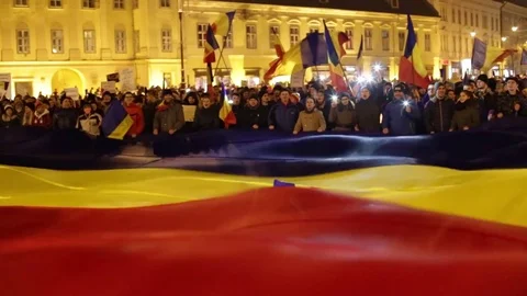 Huge crowd of protestants waving a big romanian flag Stock Footage 76991934