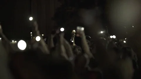 Huge crowd waveing lighted phones on a concert Vidéo 82240385
