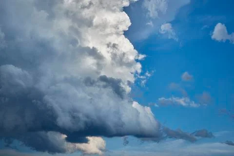 A huge dark cloud against the blue sky Stock Photos