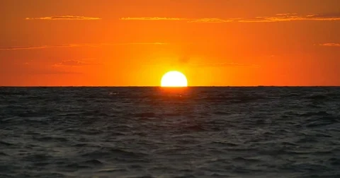 Huge disk of the sun hides behind the horizon Stock Footage 83618605