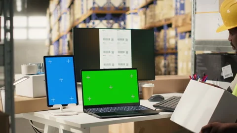 Huge distribution center worker verifying parcel details with isolated display 스톡 동영상 315538605