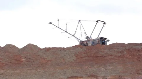 A huge dragline does the work by extracting minerals in a quarry in an open way. Stock Footage 122215282