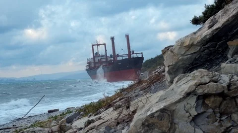 A huge dry cargo ship rio aground on a stone beach Stock Footage 127550641