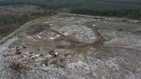 A huge dump outside the city, working cars drive garbage Stock Footage 157705984