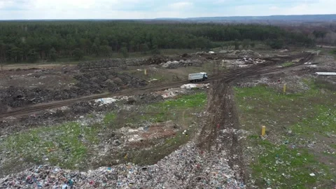 A huge dump outside the city, working cars drive garbage Stock Footage 157705988