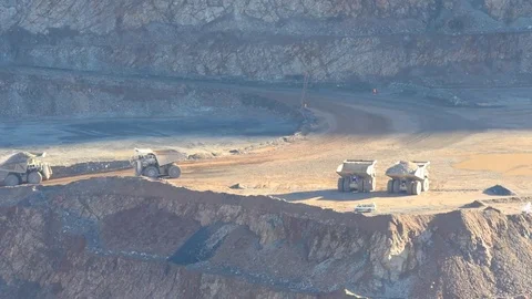 Huge dump trucks in operation at an open pit mine Stock Footage 71873996