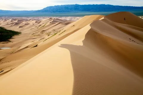 Huge dunes of the desert. Beautiful structures of sandy barkhans. Fine place for Stock Photos
