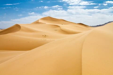 Huge dunes of the desert. Beautiful structures of sandy barkhans. Fine place for Stock Photos