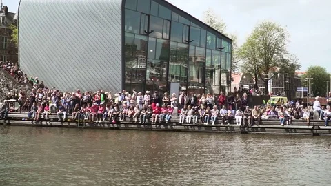Huge dutch crowd sitting next to water Gay Pride01 動画素材 78573311