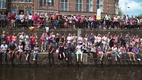 Huge dutch crowd sitting next to water Gay Pride03 Stock Footage 78573320