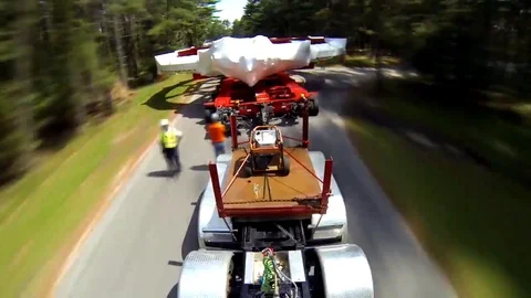 A huge electromagnet for use in a particle accelerator tarvels along roads and Stock Footage 123375593