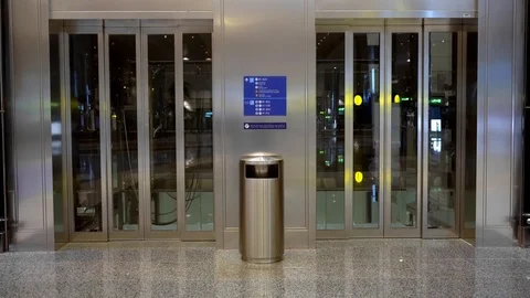 A huge elevator with two entrances arrives. The elevator goes down and opens the Stock Footage 124678847