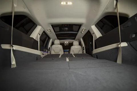 Huge empty car trunk in premium light color interior of suv. rear seats in Stock Photos