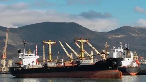 A huge empty cargo ship sails from the pier from the port Stock Footage 102681007