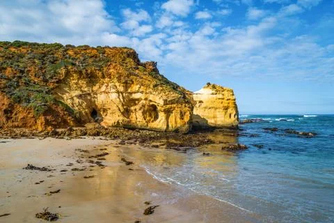 Huge eroding rocks on ocean coastline Stock Photos