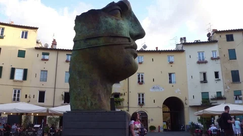 Huge face sculpture at Amphitheater Square in Lucca Stock Footage