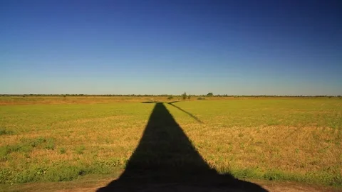 Huge Falling shadow of a windmill in a field with spinning turbine blades. Stock Footage 222417277