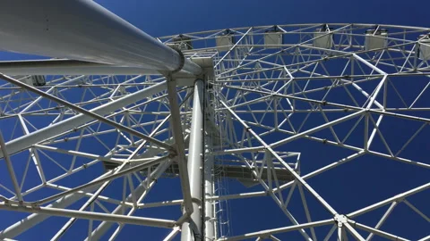 Huge ferris wheel. Bottom view. Clear blue sky. Iron construction. Fittings Stock Footage 201102126