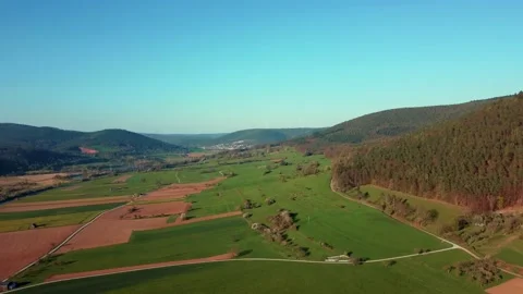 A huge field with hills around Stock Footage 154338627