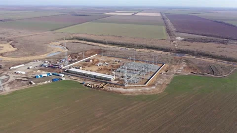 The huge fields in the background of a massive wind power plant in the making 4k Stock Footage 133558648
