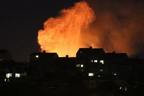 Huge fire and subsequent explosion in a residential neighborhood at night. .. Stock Photos