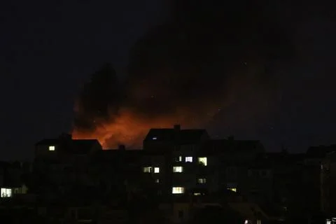 Huge fire and subsequent explosion in a residential neighborhood at night. Stock Photos