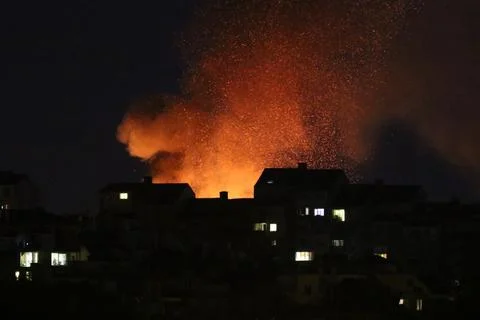 Huge fire and subsequent explosion in a residential neighborhood at night. Stock Photos