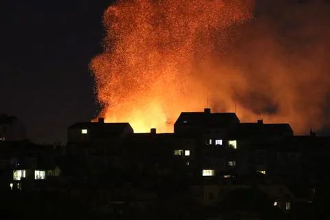 Huge fire and subsequent explosion in a residential neighborhood at night. .. Stock Photos