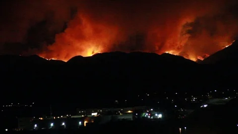 Huge fire in the mountains behind a city Stock Footage 109202963