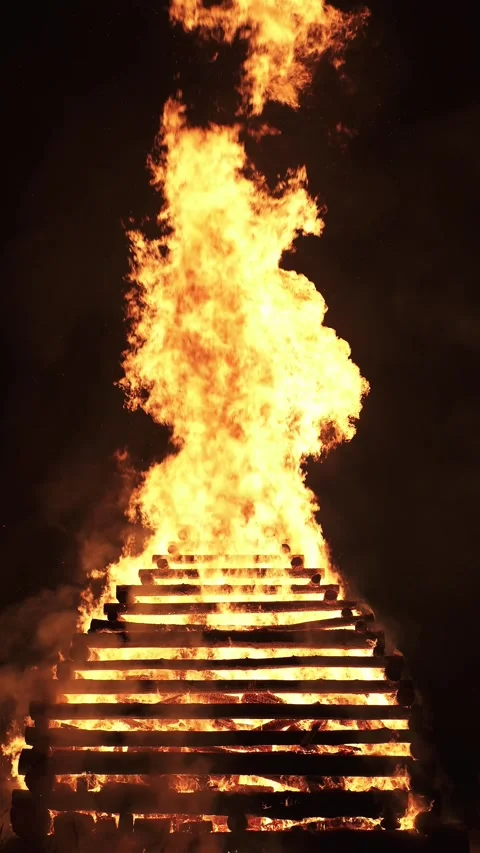 Huge Fire with Tall Flames, Burning a Wooden Pile at Night, Bonfire Festival Stock Footage 316331869