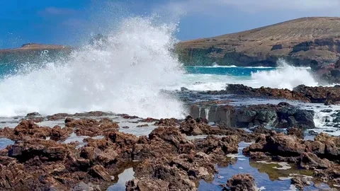 Huge foaming ocean waves crash against a rocky shore. Stock Footage 307554546