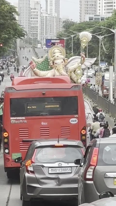 A Huge Ganesh Idol procession through a busy road on 20-07-2025 in Mumbai Stock Footage 313519092