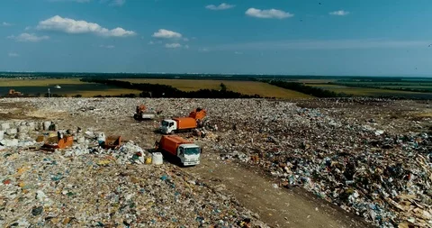 A huge garbage dump People sort out the garbage in the landfill. Seagulls Stock Footage 114470156
