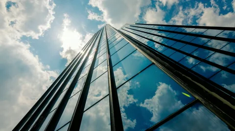 Huge Glass skyscraper dramatic sun and dark clouds reflection timelapse 25p Stock Footage 50544886