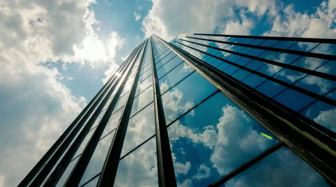 Huge Glass skyscraper dramatic sun and dark clouds reflection timelapse 30p Stock Footage 50549094