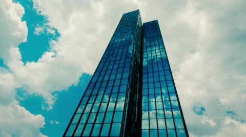 Huge Glass skyscraper sunrays and clouds reflection timelapse 25p Stock Footage 50542630